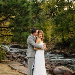 Wedding couple kiss by river