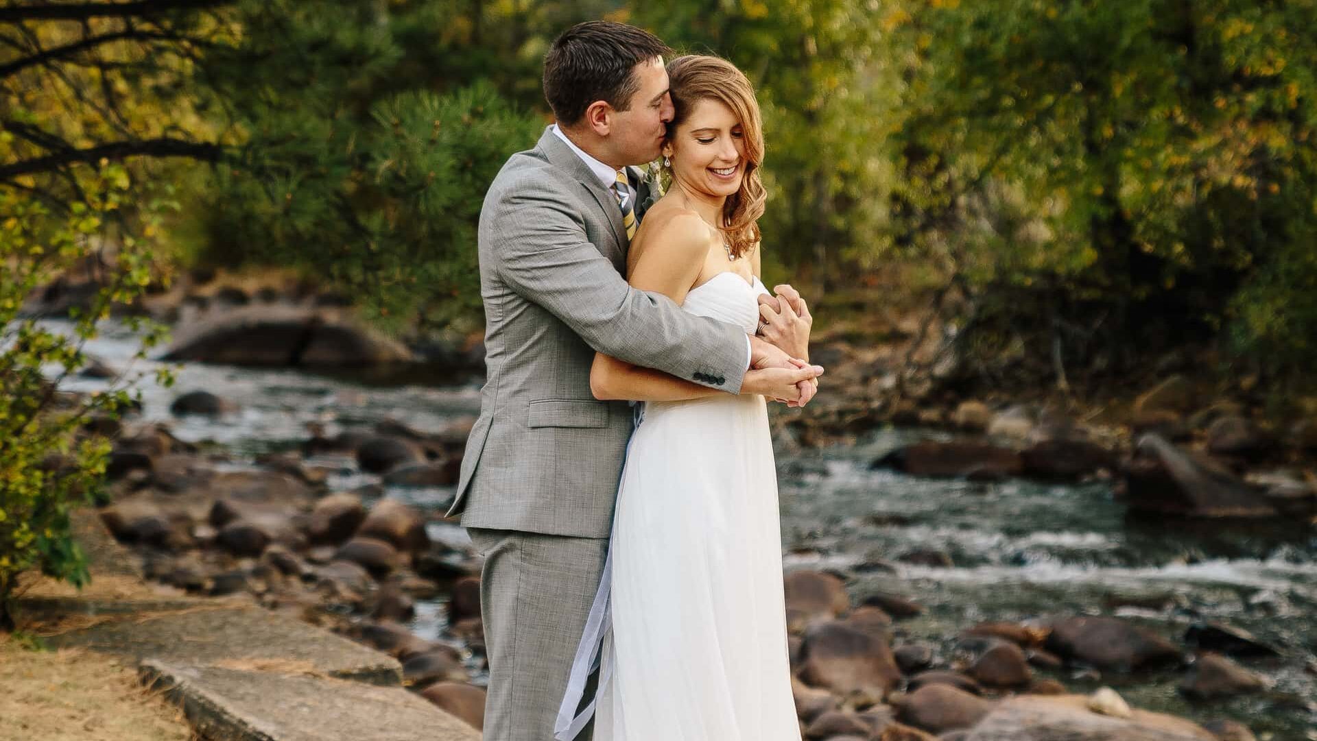 Wedding couple kiss by river